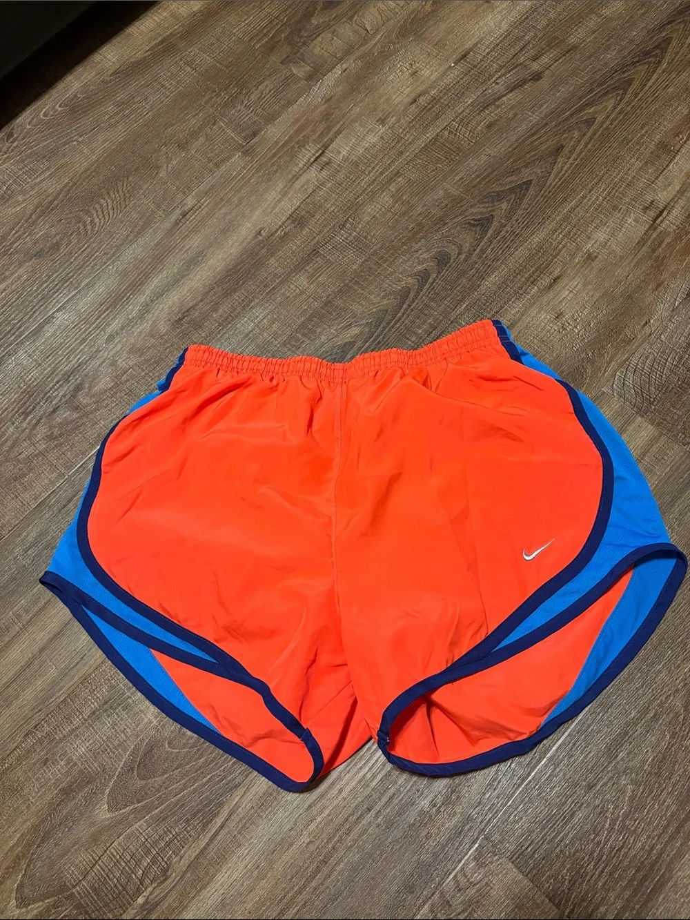 Nike Women’s medium orange Athletic Shorts with Blue Trim
